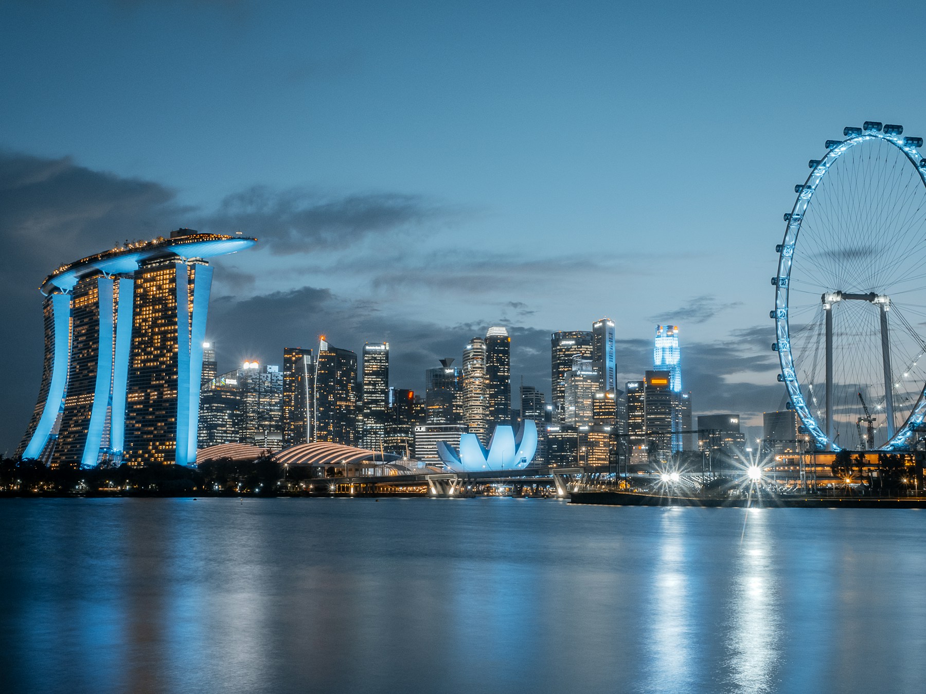 Singapore’s Marina Bay skyline and Singapore Flyer at blue hour